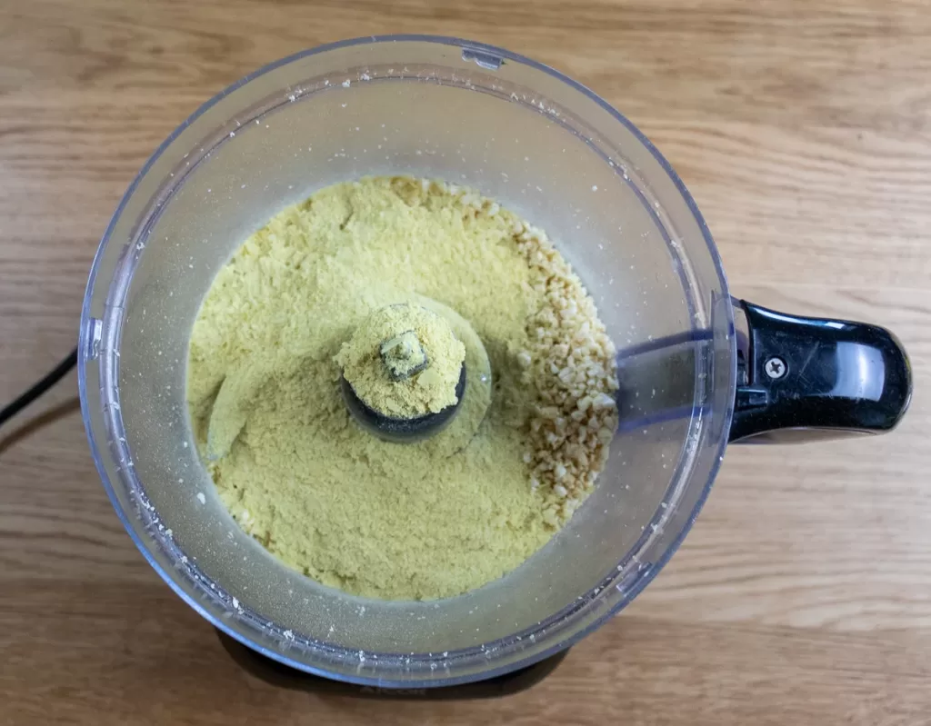 Adding the nutritional yeast into the processor