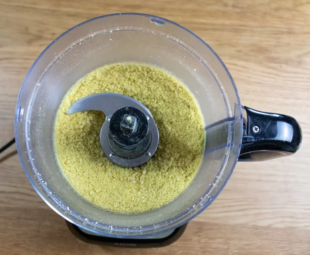 Adding the nutritional yeast into the processor and blended