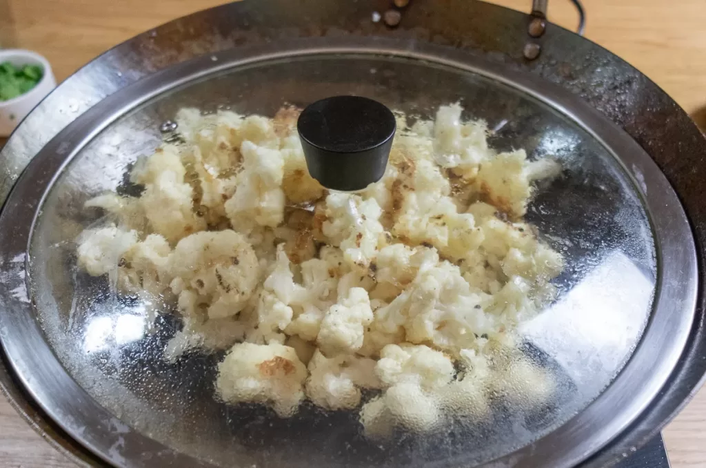Lid on cauliflower to steam