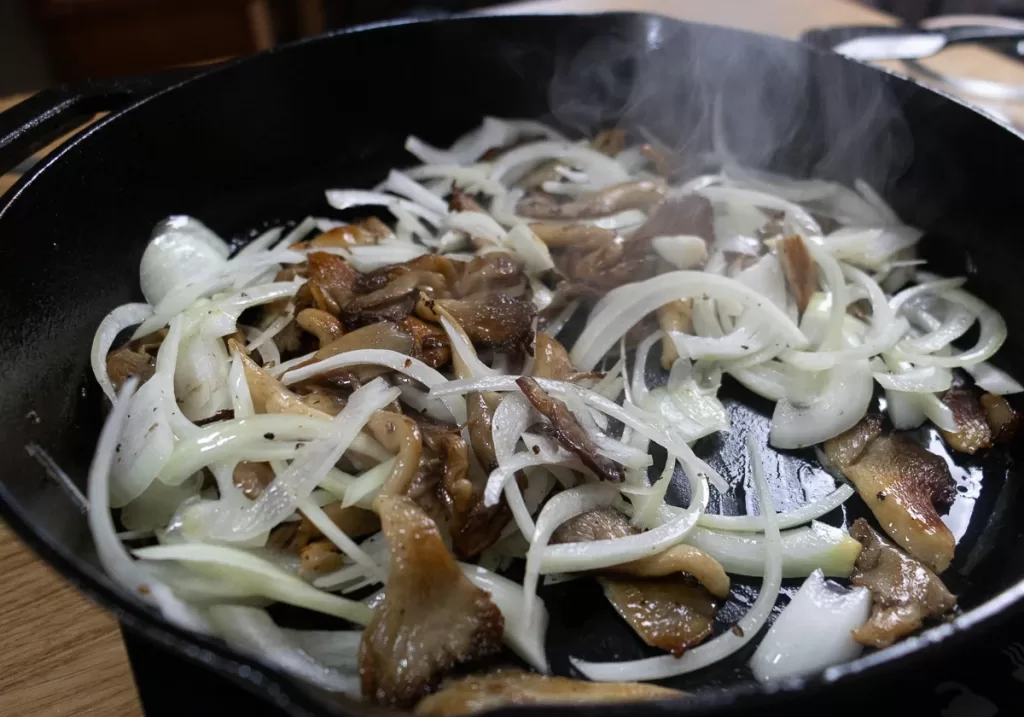 Adding onions to mushrooms