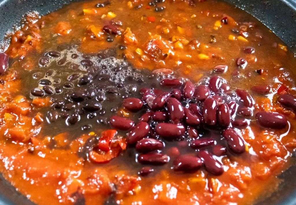 Adding beans and tomatoes