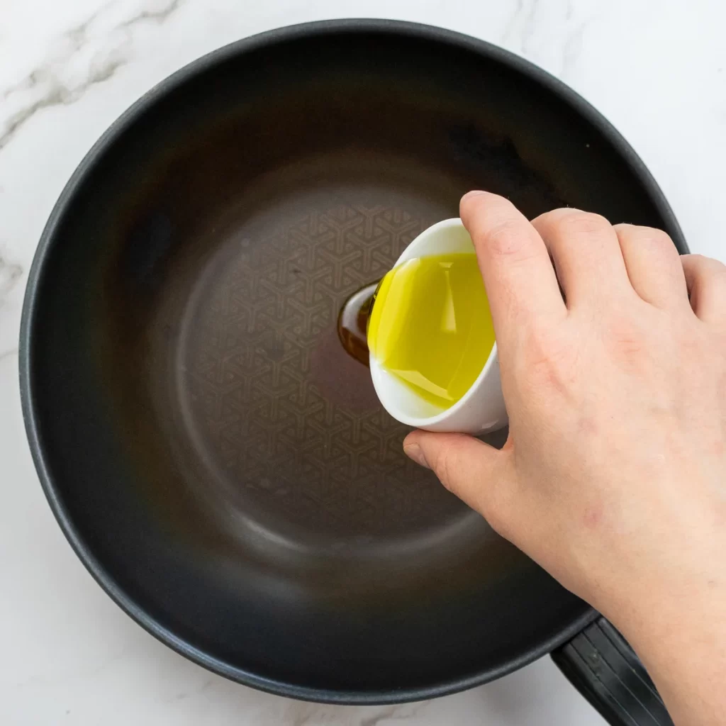 Adding oil to pan